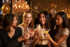 Group of female friends make a toast as they party for their small wins